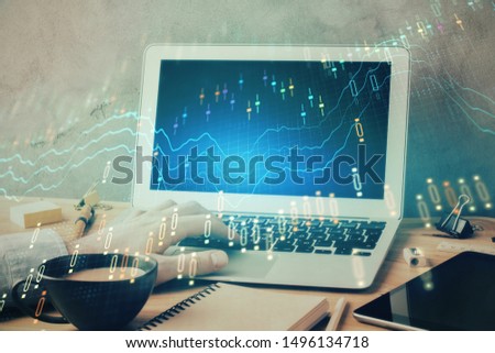 Forex graph with businessman working on laptop on background. Concept of hardworking. Multi exposure.
