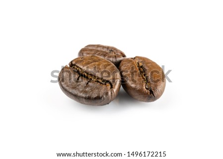 Three shiny fresh roasted coffee beans isolated on white background. Coffee background or texture concept.