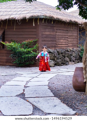 Asian little girl wearing a Korean Traditional Hanbok dress  at Ancient village