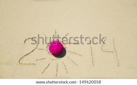 Number 2014 with christmas decoration on the sandy beach