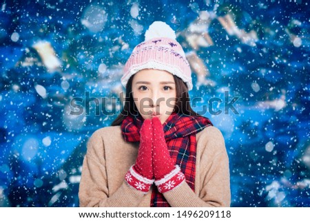 Young Beautiful Woman in winter clothes with snow background