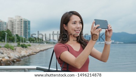Travel woman use of mobile phone for take photo at outdoor