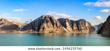 Panoramic view of the cliffs and mountains in Buchan Gulf, Baffin Island, Canada. Royalty-Free Stock Photo #1496239760