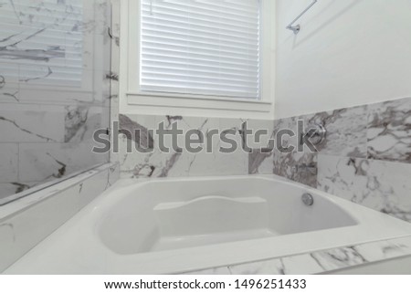 Black and white tiles at the bathroom of a home with gleaming built in bathtub