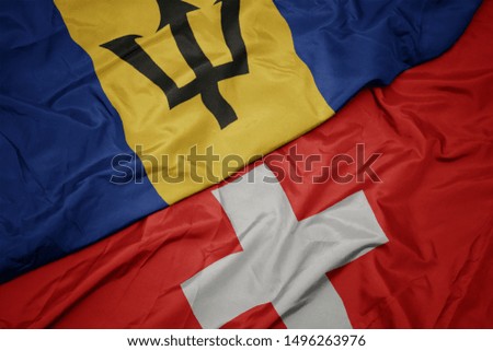 waving colorful flag of switzerland and national flag of barbados. macro