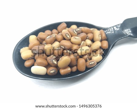 A picture of red beans on a black spoon