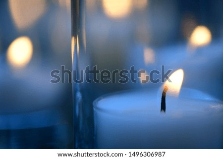 Tea candles lit in blue evening light