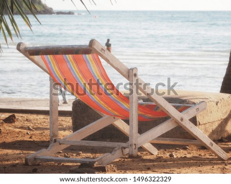 Red striped beach bed, sea view in the afternoon, holiday place to relax.