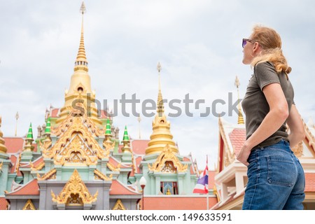 woman looks the temple in Thailand