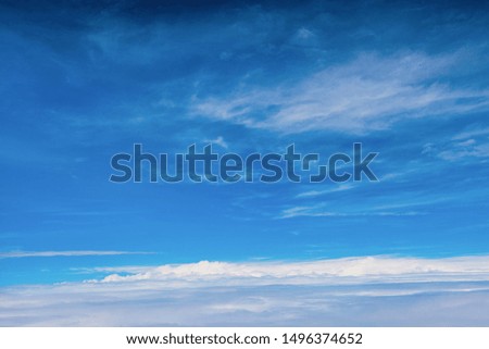 Airplane view of blue sky with white clouds in various forms 