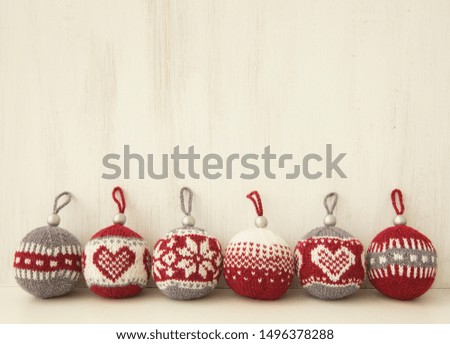 Jacquard knitted Christmas balls on white background
