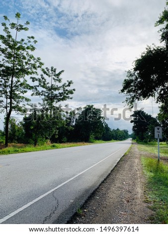 The vertical image of cement road view with trees flanked And the sign of kilometer 1 as strat point for beginning