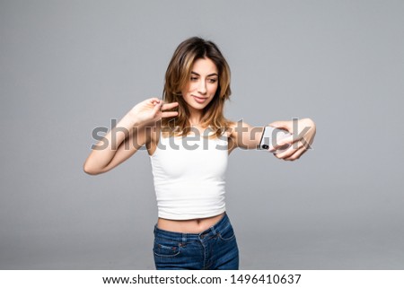 Young girl making selfie photo on smartphone over gray background