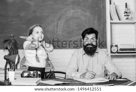 It is unbelievable. daughter study with father. Teachers day. knowledge day. Home schooling. back to school. Private teaching. private lesson. small girl child with bearded teacher man in classroom.
