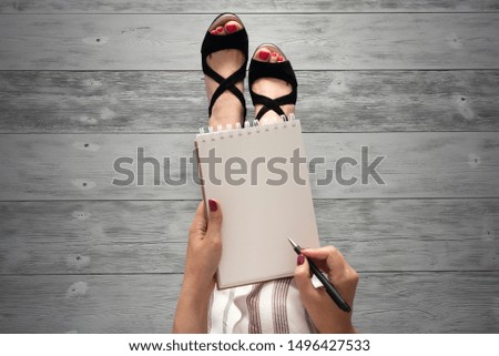 Woman legs in a high heels shoes and a blank page notepad. Women tips. Female tricks mock up. 