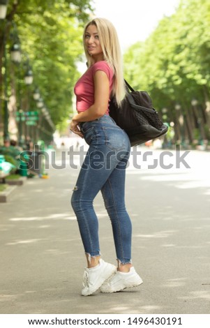 Young pretty blonde girl in autumn park.