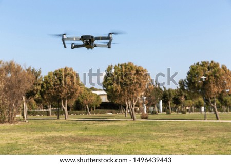 A drone with digital camera flying in the park