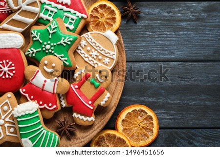 Flat lay composition with tasty homemade Christmas cookies on dark blue wooden table
