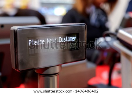 cashier digital display with words please next customer  Royalty-Free Stock Photo #1496486402