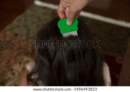 the louse on the girl's hair. pay attention to  lice.