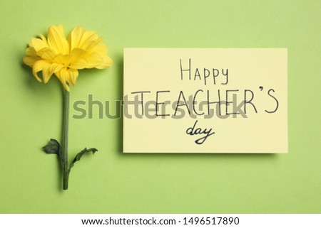 Paper with inscription HAPPY TEACHER'S DAY and flower on light green background, flat lay