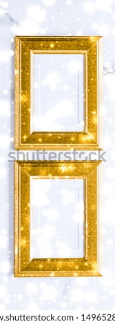Art gallery, printable poster and online shop mockup concept - Golden photo frame and glowing glitter snow on marble flatlay background for Christmas and winter holidays