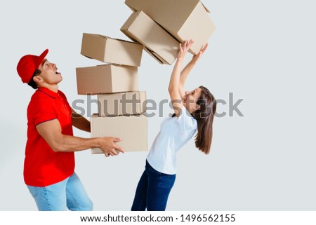 Screaming handsome male in red uniform with falling stack of boxes. Women try to accepting delivery from delivery man. White background image of delivery service worker giving boxes to client.
