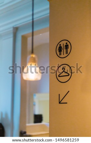 Light and bathroom signs on the wall