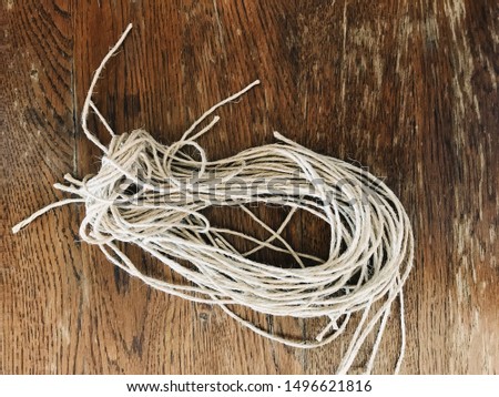 Strings are ready to use for handcrafts on wooden table.