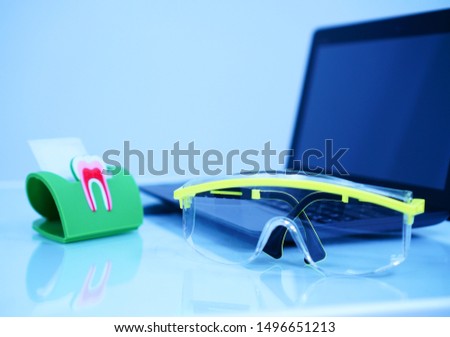    Dental glasses and laptop on the table                            
