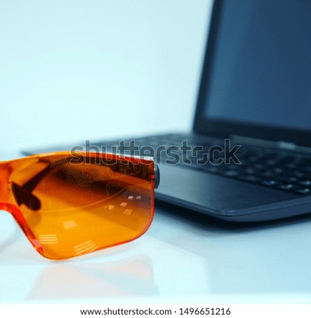    Dental glasses and laptop on the table                            