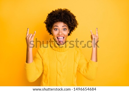 Reaction on listening to favorite music concept. Closeup photo portrait of emotional nice optimistic positive wild teenager making heavy metal sign stick tongue out isolated vibrant color background