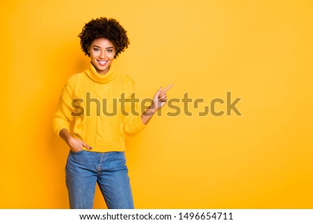 Photo of dark skin lady indicating finger empty space wear warm knitted pullover isolated yellow color background