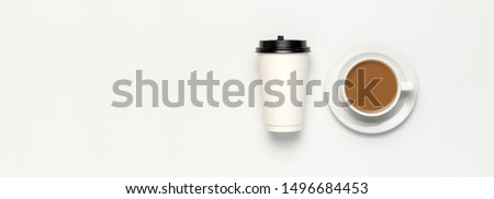 Coffee or tea paper cup, white cup with coffee on light gray background top view flat lay copy space. Take away coffee cup, mockup. Minimal composition, layout for design. Long banner