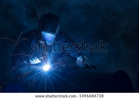 Highly skilled welder workers are welding in the construction site in the factory. Royalty-Free Stock Photo #1496684738