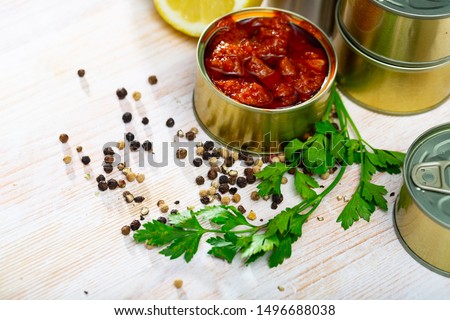 Picture of  tasty squids in American Salsa on background with greens and lemon 