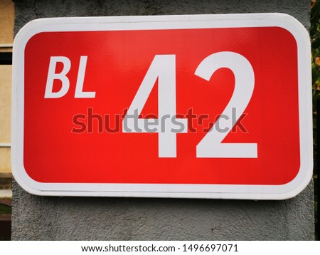 closeup of sign for block numeral forty two number 42 in vivid red and white lettering text