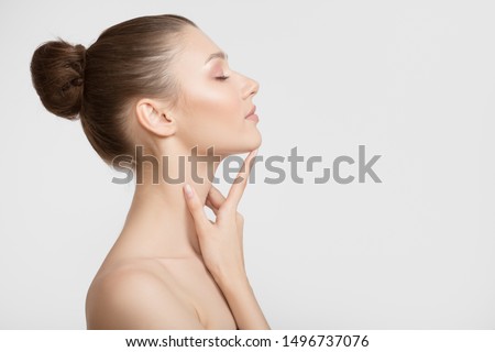 Portrait of a young woman. Bare shoulders. Hand touches face Royalty-Free Stock Photo #1496737076