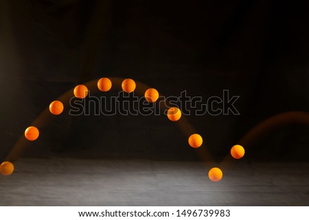 table tennis ball bouncing on table with black background,ping pong ball bouncing on table. Royalty-Free Stock Photo #1496739983