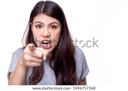 Asian woman repine or scold someone who is making her mad, frustrated, angry. Beautiful young girl pointing finger to boyfriend or enemy and nag him. She get unsatisfied. isolated on white background Royalty-Free Stock Photo #1496757368