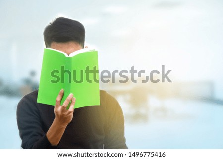 Young Asian student reading a book 