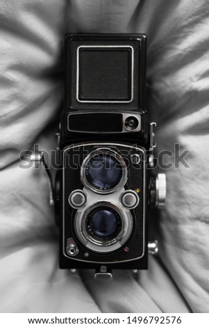 An old twin reflex camera on a soft background
