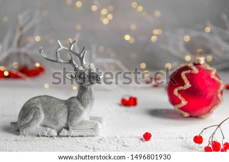 Christmas. New Year's composition of silver deer and red christmas ball. garland lights. fairy forest