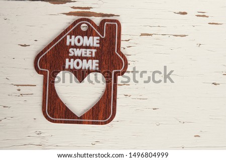 Home sweet home, house wood on a white wooden background