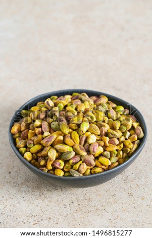 pistachio nuts on granite surface