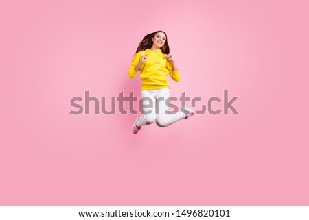 Full length body size photo of charming cute nice attractive beautiful fascinating girlfriend jumping up to air wearing yellow sweater footwear isolated over pink pastel color background
