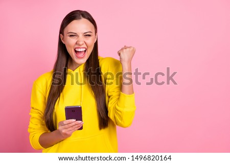 Copyspace photo of beautiful cute attractive sweet gorgeous cheerful white girlfriend holding telephone rejoicing with being liked wearing yellow sweater isolated over pink pastel color background