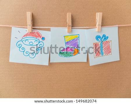 post it reminders and clothespins attached to a rope with drawing cartoon on brown paper background with clipping path,Santa Claus,Gift,sock,Christmas,New year,Holiday
