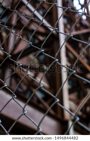 chain link fence in front of steel building supports