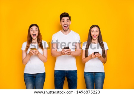 Portrait of three nice-looking attractive lovely winsome cheerful cheery glad person using wi-fi connection speed 5g app free time isolated over bright vivid shine yellow background
